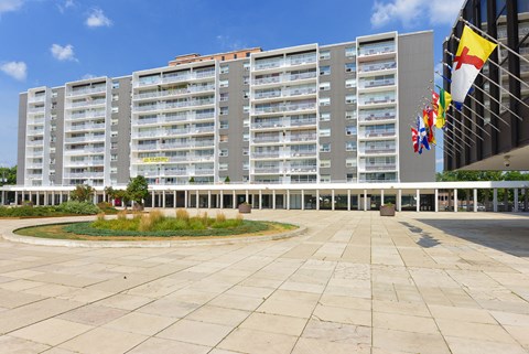 a large building with flags in front of it